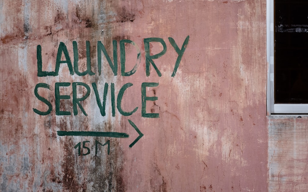 A photo of a wall with Laundry Service written on it.